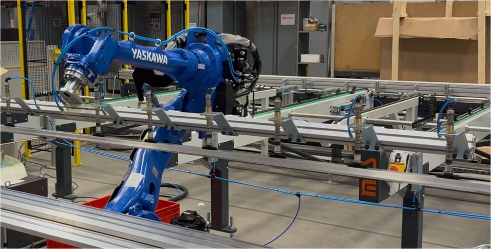 The robotic loading system in action as it moves an aluminium profile